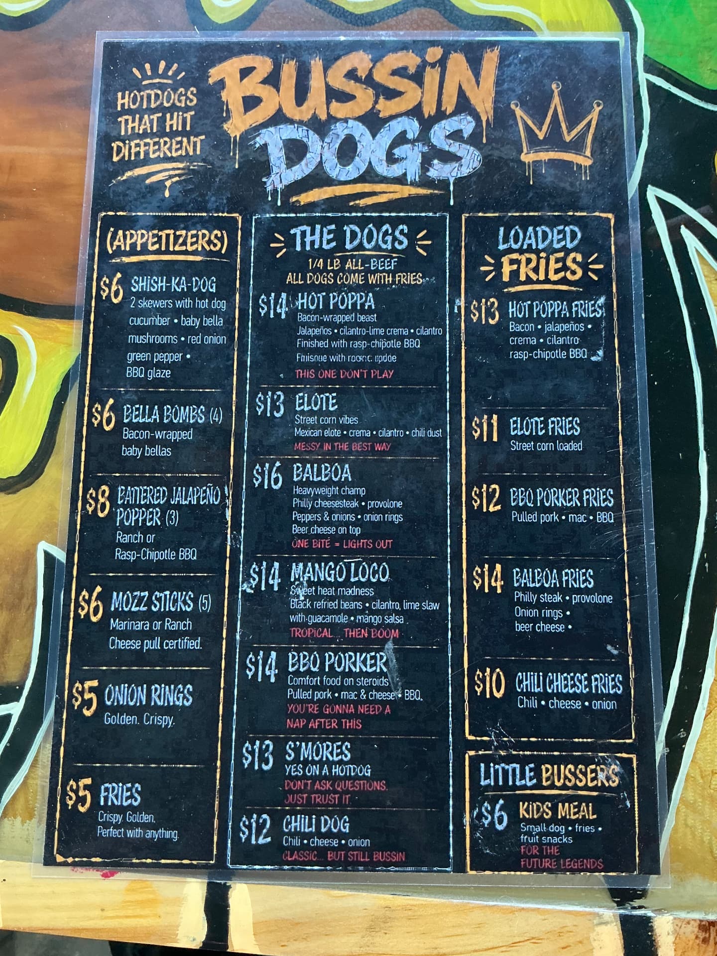 Photographed Bussin Dogs menu board with dogs, appetizers, loaded fries, and kids meal prices
